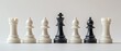 © Bassmallah - Black King chess piece stands out from white pawns and rooks on white background.