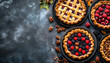 © Oleksiy - Autumn Pies on rustic background, top view, copy space. Homemade seasonal pastry - berries and pecan pies or tarts for Thanksgiving and autumn holidays