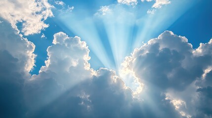 dramatic sunlight beams emerging through soft clouds in a bright blue sky creating a serene and upli