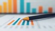 © Sirichai - Financial Planning: A close-up shot of a pen resting on a financial report, with bar graphs showing upward trends in the background, suggesting growth and progress.