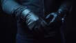 © AbstractAI - Man in black protective leather gloves adjusting his grip against a dark blue background with dramatic lighting and focused detail.