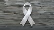 © Been - Grey Ribbon on Wooden Background: Cancer Awareness Concept Top View