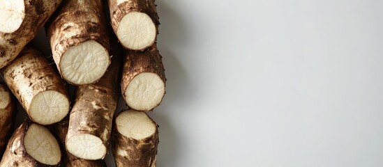 Wall Mural - Freshly harvested horseradish roots arranged on a light background with ample copy space for text or graphics.