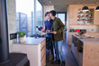 © Caia Image - Gay couple kissing in kitchen