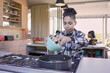 © Caia Image - Boy cooking in kitchen