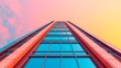 © Sirichai - Reaching for the Sky: A modern skyscraper, captured from a dramatic low-angle perspective, its glass facade reflecting a vibrant sunset sky, evokes a sense of ambition and architectural marvel.