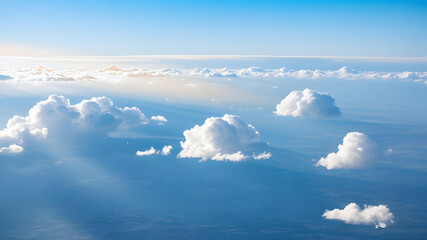 Wall Mural - calm blue ocean under a clear sky dotted with clouds, the cloud scape from flight: endless softness,
