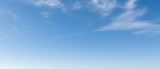 vast blue sky with wispy cloud trails, dreamy feel