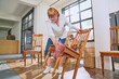 © Caia Image - Visually impaired woman cleaning chair