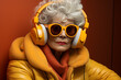 © Evdoha - ultra fashionable elderly woman in headphones listening to music,.  Generative AI