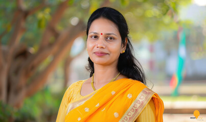 Wall Mural - Elegant Indian Woman in Traditional Yellow Saree with Beautiful Natural Background and Soft Smile Radiating Joy and Culture