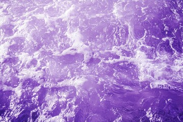 Wall Mural - violet colored clear water. crystal clear ocean water surface on a tropical exotic beach.