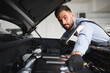 © Serhii - Troubleshooting process. Auto mechanic working in garage. Repair service
