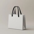 © black - White paper shopping bag with black handles on neutral background.