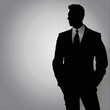 © Grace - silhouette of man in suit, exuding confidence and professionalism against light background. This captures essence of business and elegance