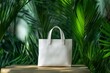 © Nico - Minimalist White Tote Bag Against Lush Green Background