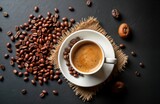 White lungo cup with hot coffee. Toasted coffee beans scattered on rustic black table. Top view. Copy space. Coffee bean background. Aromatic drink. Natural ingredients. Perfect for food blog.