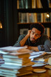 © stanhert - A man sitting at a desk with a pile of papers in front of him