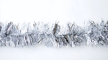 Wall Mural - silver tinsel on white background, festive holiday decoration.