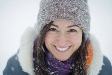 Sticker - A woman wearing a hat and scarf stands in the snowy landscape