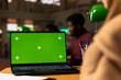 © DC Studio - Young student working with a green screen in the university campus library, collecting academic information from verified educational sources. Female pupil using research tools for diploma project.