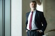 © opolja - Portrait of a confident mature businessman standing in a modern office