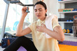 © Pixel-Shot - Sporty young woman with inhaler and towel having asthma attack in gym