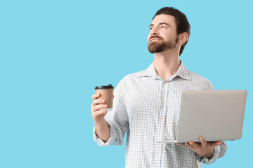 Sticker - Handsome man with laptop and coffee cup looking upwards on blue background