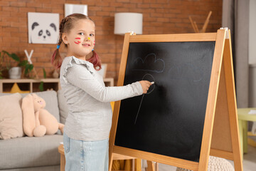 Poster - Little girl in paint drawing on chalkboard at home