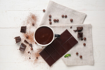 Canvas Print - Cup of hot chocolate with balls, cocoa powder and mint leaves on white wooden background