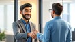 © Rika - Two smiling businessmen shaking hands in an office