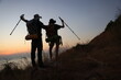 © naraichal - A couple of backpackers  trekking during sunset over the horizon