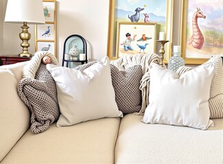 Wall Mural - Blank light lavender pillow on a cozy sofa, surrounded by soft textures and plush throws.