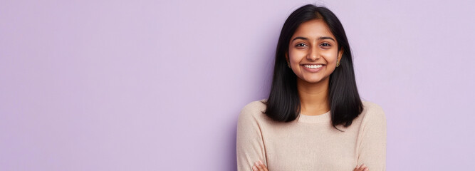 young indian woman smiling on purple background