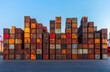 © ANUAR - Industrial Shipping Containers Stacked in Urban Port Setting with Rusted Exteriors and Clear Blue Sky Highlighting Maritime Logistics and Trade Operations