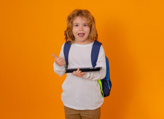 Fototapete - Pupil, nerd schoolboy. School boy with tablet. School kid student learning at school. Elementary school child. Portrait of nerd pupil, isolated on studio background