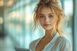 © Olesya - Smiling mature business woman in office holding tablet happy executive entrepreneur looking away at copy space