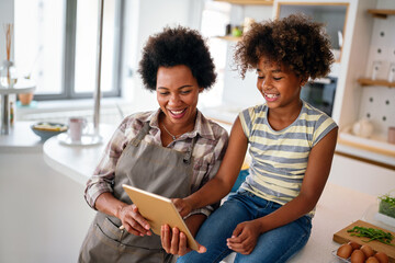 Wall Mural - happy african american single mother helping child with distance education. online education