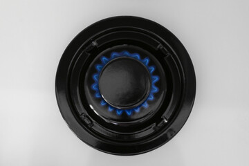 Wall Mural - Gas burner of modern stove with burning blue flame, top view