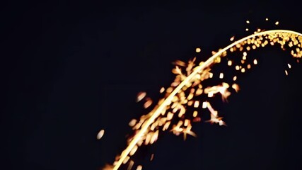 Leinwandbilder - Sparkling golden particles create mesmerizing patterns in dark background during a celebration