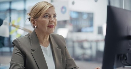 Poster - Portrait of an Adult Manager Reviewing Sales Reports on Desktop Computer. She is Working with Business Data to Identify Key Trends and Financial Opportunities in a Modern Office Workspace