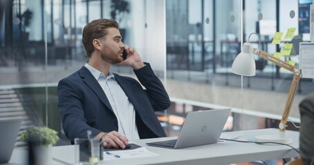 Aufkleber - Sales Representative Closing a Sale Deal on a Phone while Updating Customer Information on Laptop Computer. Young Man Provides Customer Service and Builds Professional Relationship with a Client