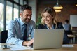 © Fazla - Happy Professional Business Man and Woman Working on a Laptop at an Office Meeting, Two Busy Colleagues Collaborating and Discussing a Business Plan Together. Generative AI