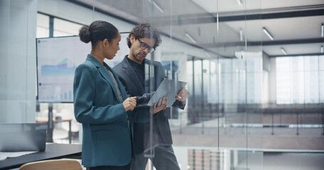 Poster - Coworkers Planning Next Business Steps in a Team Meeting, Using a Laptop Computer to Schedule Tasks and Assign Responsibilities. Multiethnic Male and Female Utilizing Project Management Software