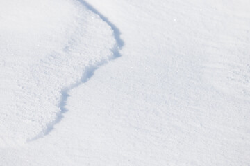 A jagged curve line on fresh white snow surface background