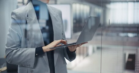 Aufkleber - Anonymous Caucasian Woman Using Laptop Computer while Standing in an Office Behind a Glass Wall. Manager Browsing Internet, Checking and Answering Emails, Typing a Message, Researching Online Data