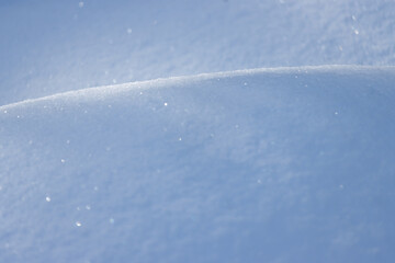 Wall Mural - curve line of natural light on sparkling snow abstract background texture