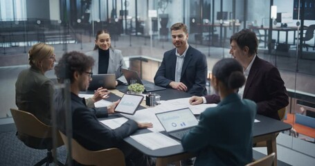 Aufkleber - Young and Middle Aged Team Members Collaborate on a Project Plan in a Modern Glass Conference Room. Diverse Male and Female Colleagues Work Together to Set Financial Goals and Assign Responsibilities