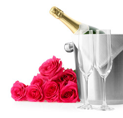 Wall Mural - Bottle of champagne in ice bucket, beautiful roses and empty glasses isolated on white