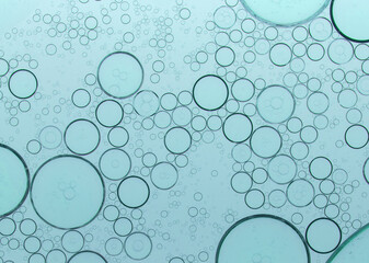 macro microscope green bubble texture, close-up green bubbles and drops oil background . blue green 
